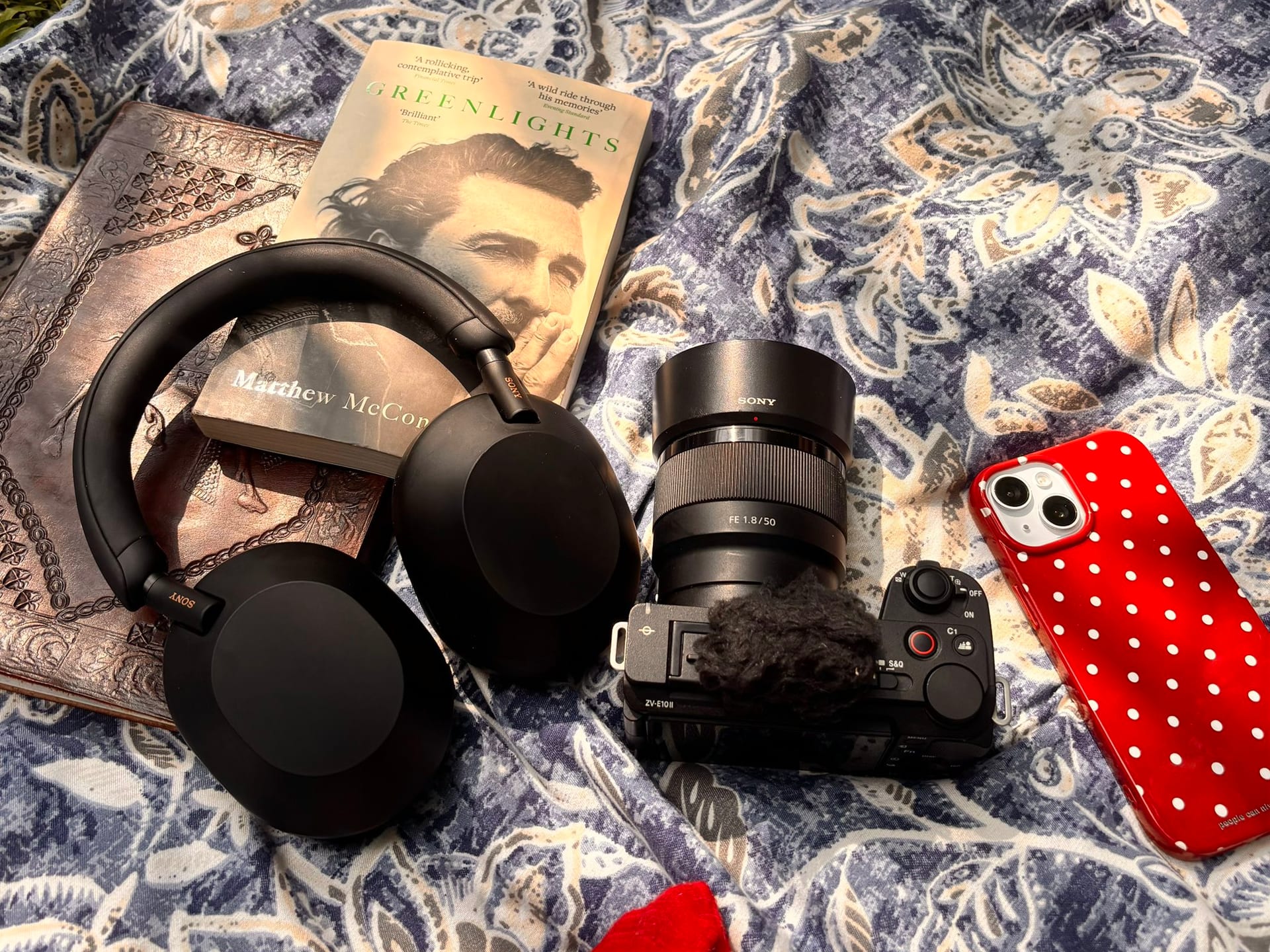 Camera, headphones and a book laid out at a co-build